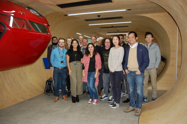 Photo of group in Autotrader's reception, with a Mini half way up the wall