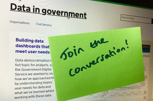 Green post-it note on a computer screen with the following words written on it: "Join the conversation!"