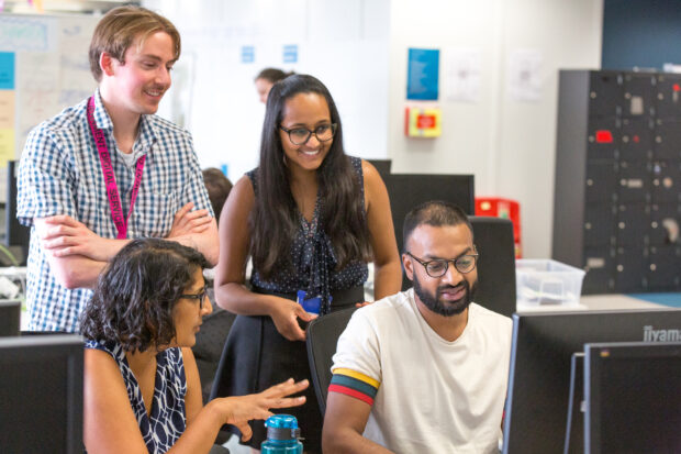 photo of four members of the Related Links team all viewing a computer screen