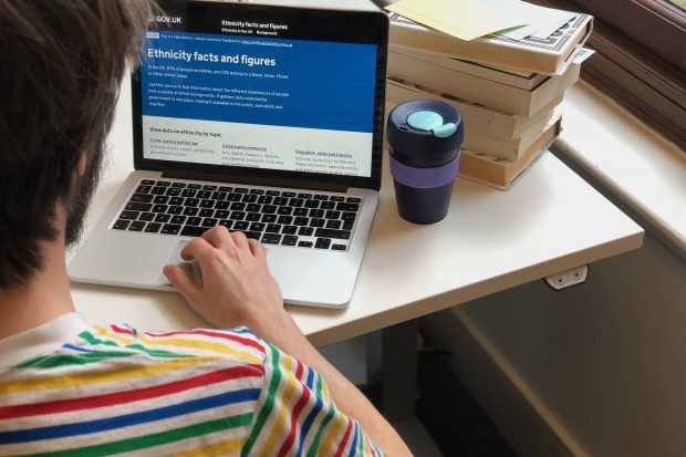 View over the shoulder of a person looking at the Ethnicity Facts and Figures website on a laptop